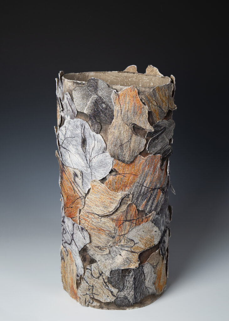 Terri Shinn's Fabric Art Vessel that looks like tree bark in soft grays, rust, and brown